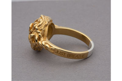 gold ring with Just Breathe written on it