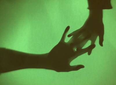 silhouette of hands on green background