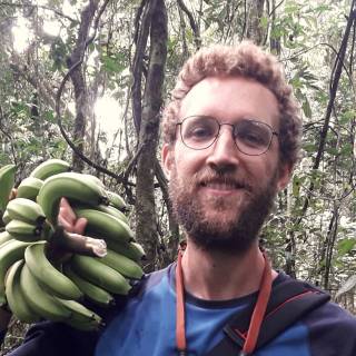 Simon Hoyte holding a bunch of bananas 