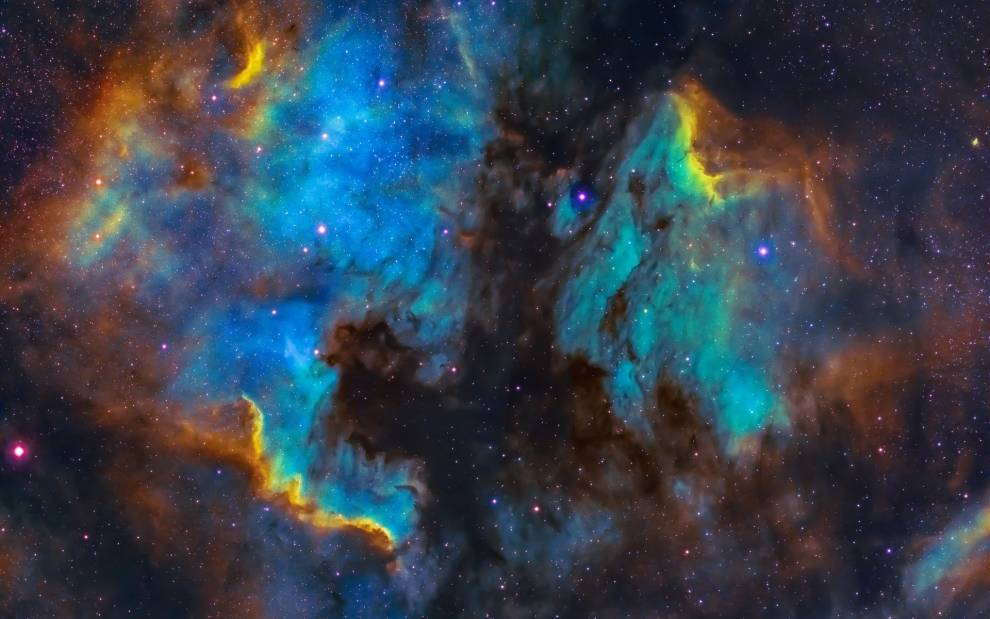 a nebula in deep space filled with colours : yellows, blues and reds, all drifting around like smoke