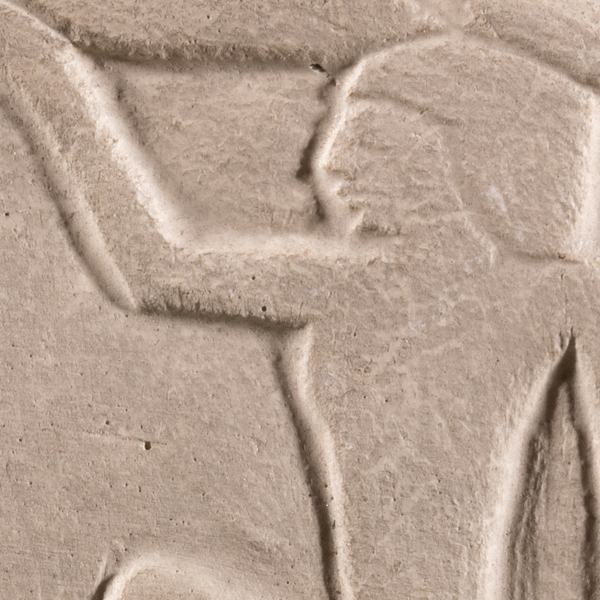 Detail of a plaster cast hieroglyph showing a human figure in profile facing left