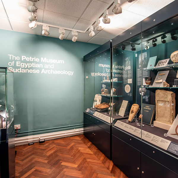 Petrie Museum entrance gallery showing objects in cases on two sides
