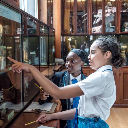 School students look at animal displays in Grant Museum of Zoology