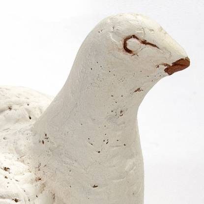 Colour photo of a white bird rattle from the Petrie Collection 