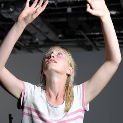 Author and actor Nell Hardy with arms raised in performance of I, Lord