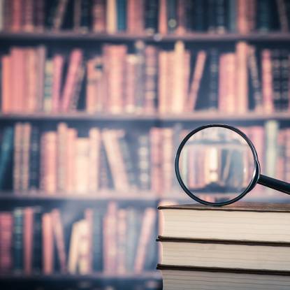 magnifying glass and books