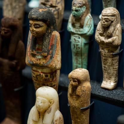 Colour photo of shabti figures arranged in rows 