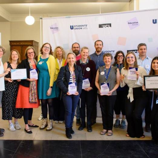 A group of staff holding Education Awards in 2023.