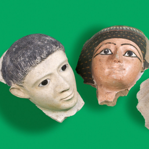 Photograph of two ancient Egyptian artefacts of clay pottery faces.