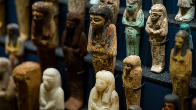 Colour photo of small human shaped shabti figures