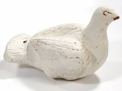 Colour photo of a white bird rattle from the Petrie                Collection 