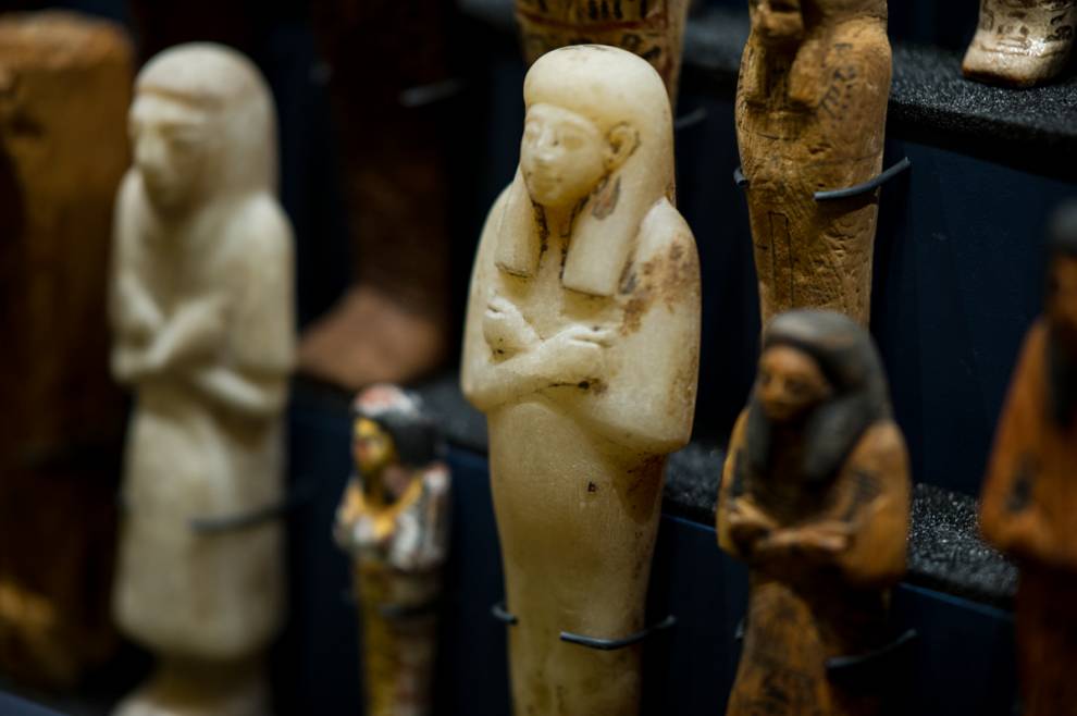 Colour photo of small ceramic Egyptian shabti figures, in human form