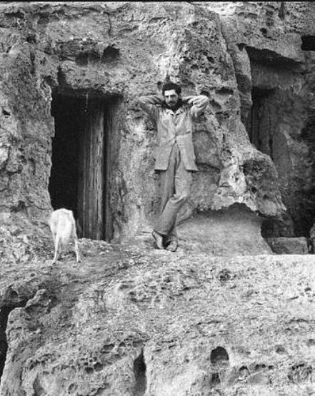 Petrie in front of the tombs he lived in at Giza. Photo copyright the Egypt Exploration Society.