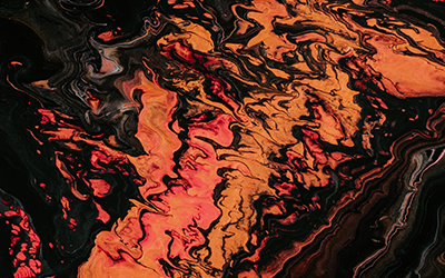Painting of fluid orange and black colours, photographed by Paweł Czerwiński via unsplash.com.