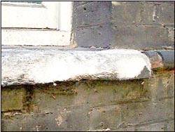Damaged portion of window sill revealing oolites in the limestone