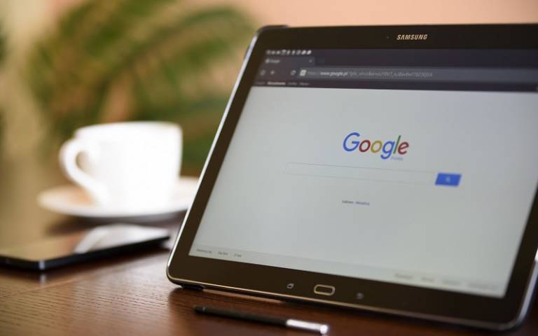 tablet showing google search engine on a desk
