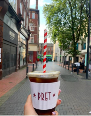 Image of a pret coffee cup with a london street in the background
