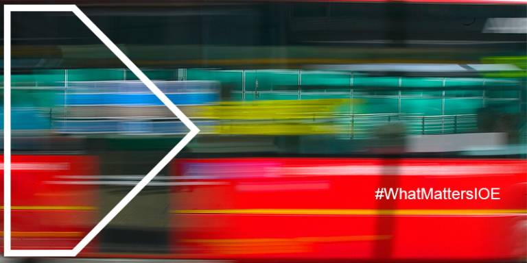 a blurred red bus with a white arrow outline and the hashtag #whatmattersioe