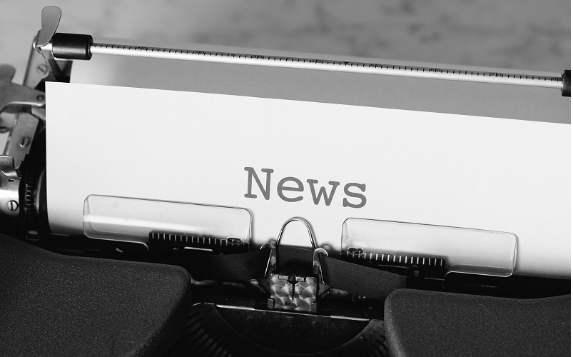 Typewriter displaying the word news on paper 
