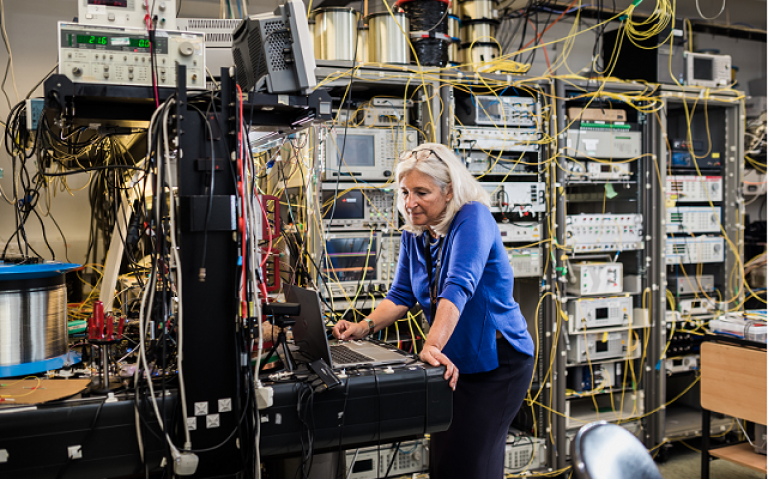 Professor Polina Bayvel standing in the optical networks lab