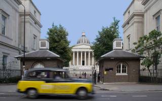 Taxi driving past the UCL Portico building