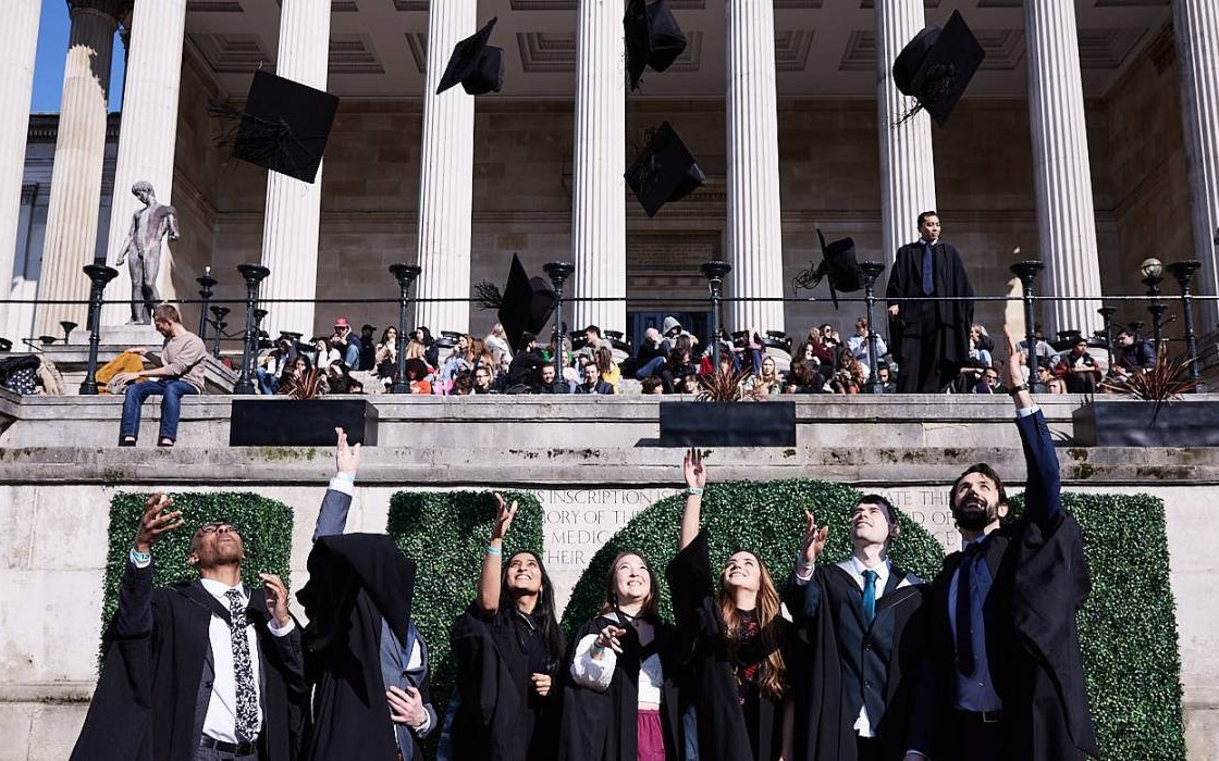 UCL graduates in front of Portico