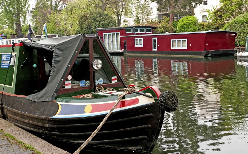 An image of two canal house boats moored in a canal