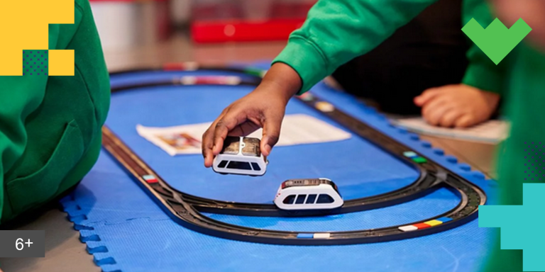 Close up of two children playing with a train set