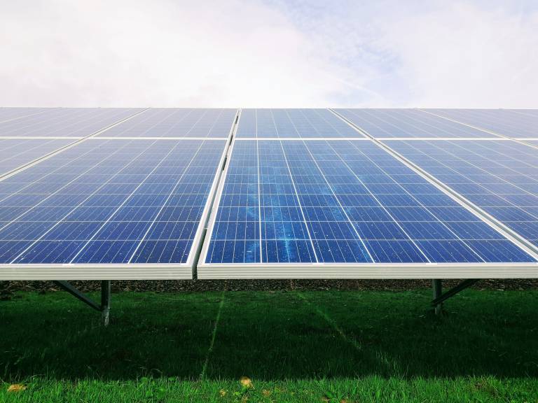 Solar Panels above a field of green grass