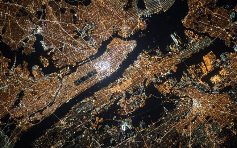 Aerial view of Manhattan at night, image taken by NASA, from Unsplash. 