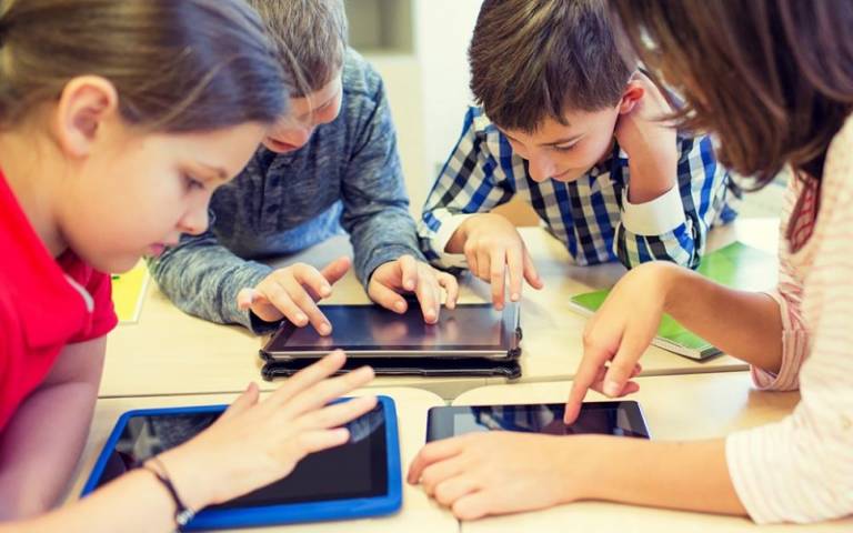 School children using tablet computers