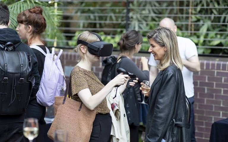 Group of people networking, with one person wearing a VR headset