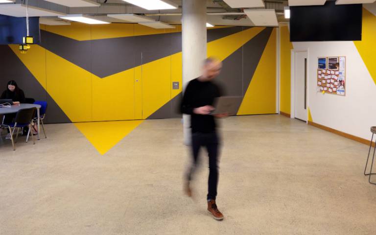A person strides through the open plan space at BaseKX