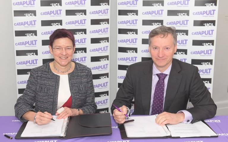Dr Celia Caulcott from UCL and Paul Campion from Transport Systems Catapult (TSC) signing a partnership between UCL and TSC