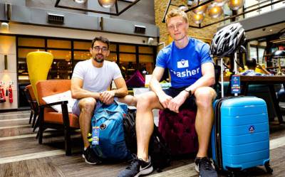 The two founders of Stasher, sitting among a number of bags and suitcases