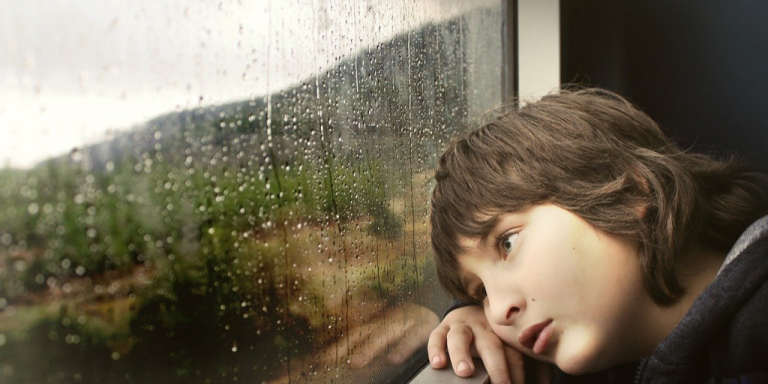 Sad child at window
