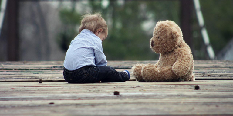 Small child and teddy bear