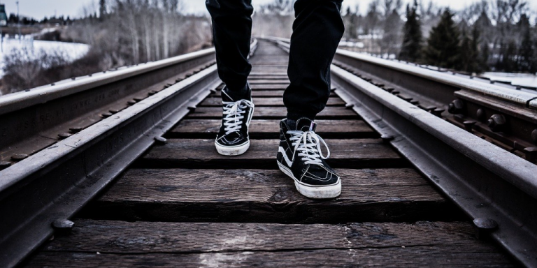 Youth walking on railway line