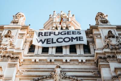 "Refugees welcome" sign hung on a building.