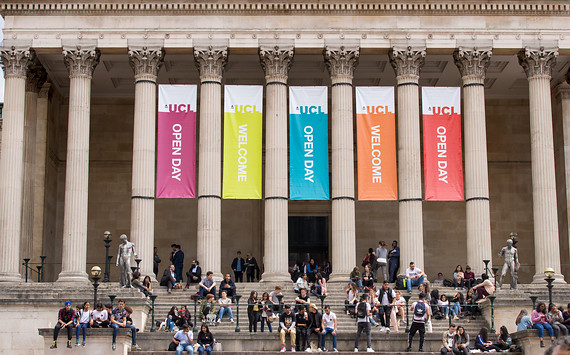 UCL's main Portico building with rainbow banner flags between the building columns