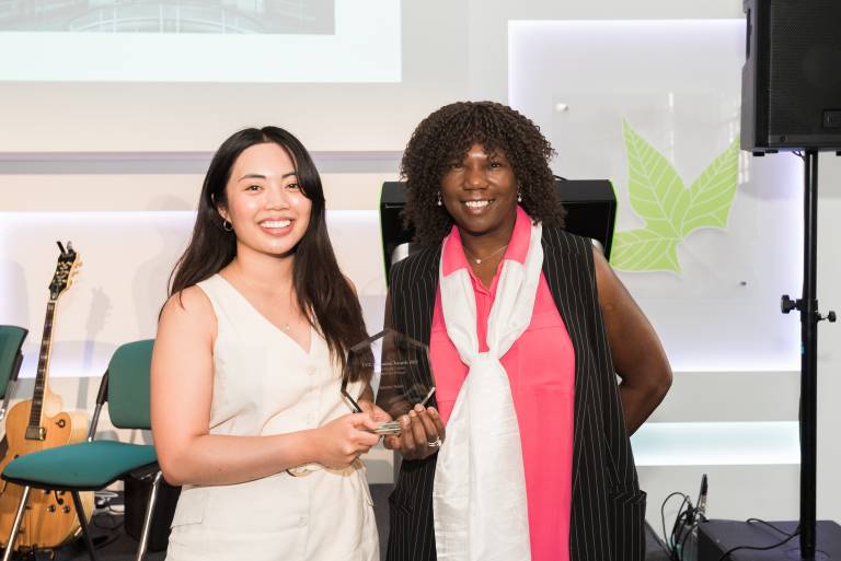 Photograph of Christine Madla, being presented her award by Femi Otitoju, from Challenge Consultancy. 
