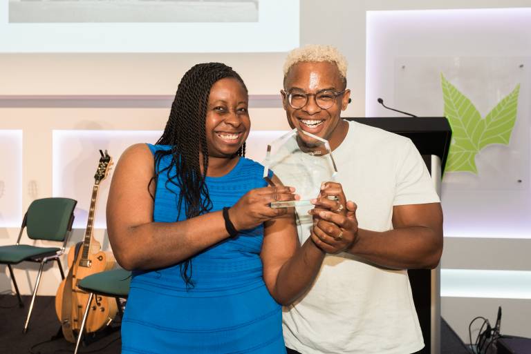 Photograph of Nnenna Kanu being presented her award by Noel Caliste.