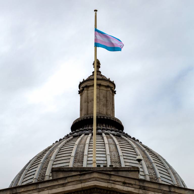 Trans flag flying above the portico