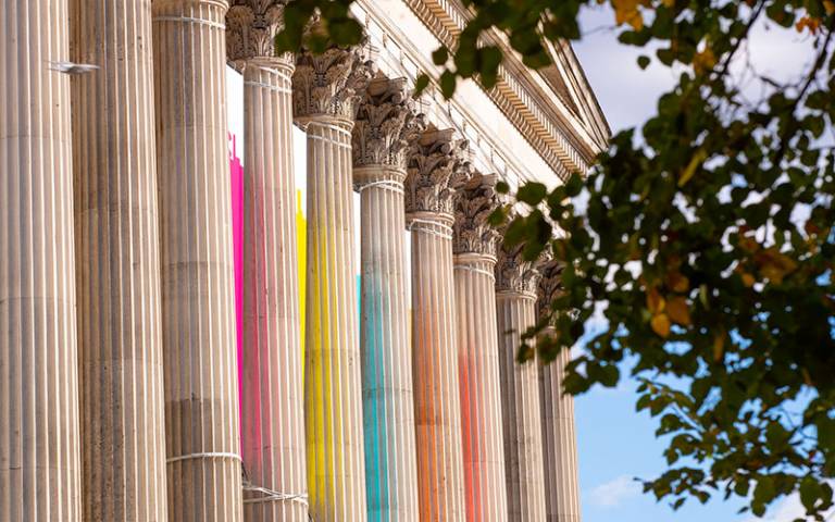 side view of the portico columns with colourful flags flying in between