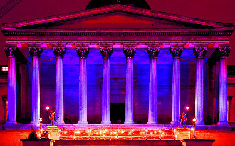image of UCL Portico lit up at night time