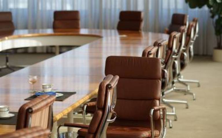 Decorative image of company boardroom with empty chairs