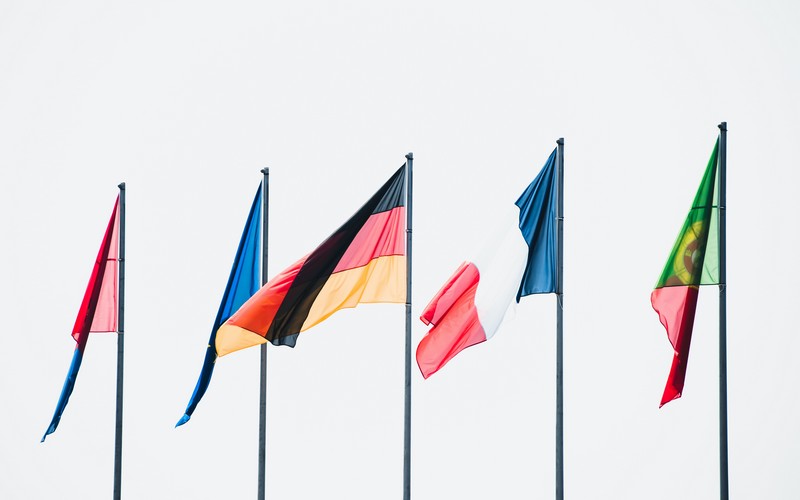 5 European flags blow in the wind.