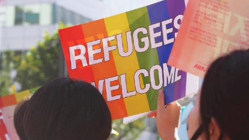 A rainbow Refugees Welcome sign