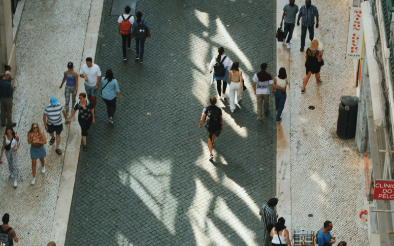 A birds eye view of people walking on a busy street in Lisbon