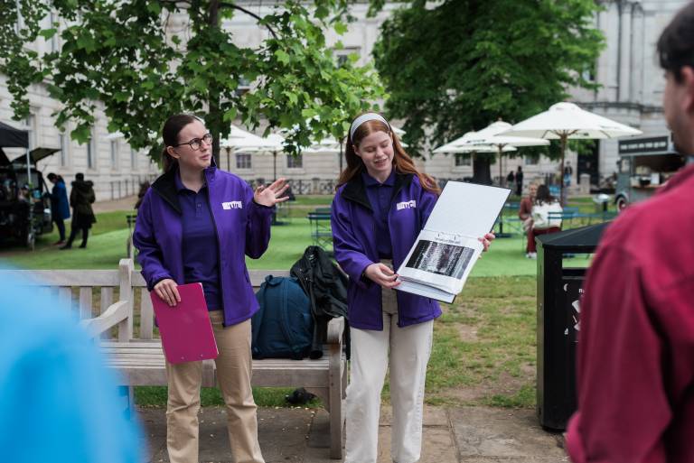Two tour guides delivering material to the UCL Walking Tour attendees